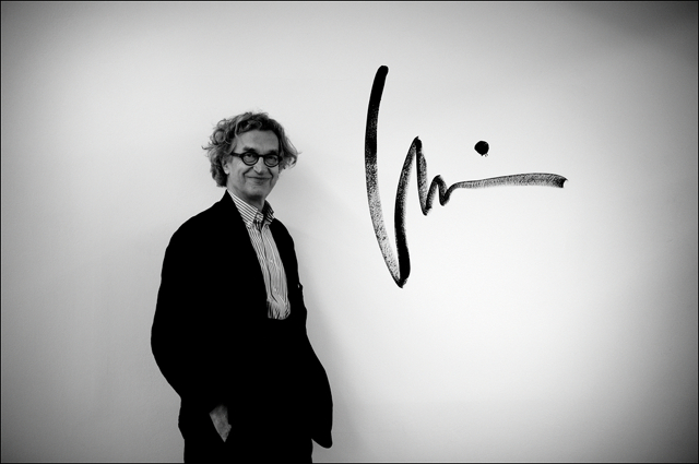 Wim Wenders posing in front of his signature